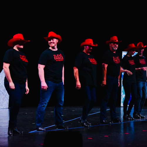 Adult tap dancers on stage