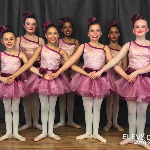 Teenage ballerinas in pink costumes
